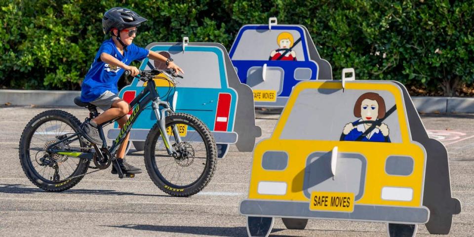 A boy moves through the obstacle course at the Rancho Santa Margaritas Bike Rodeo in the parking lot of the Bell Tower Regional Community Center in Rancho Santa Margarita on Sunday, August 7, 2022.