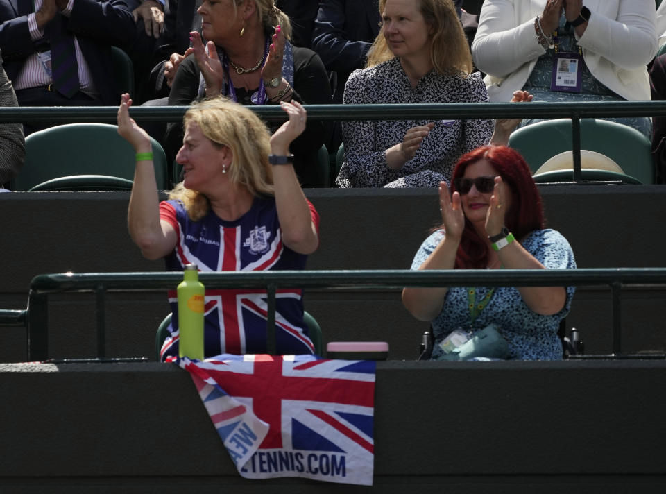 Tennis fans watch the women's singles third round match between Britain's Emma Raducanu and Romania's Sorana Cirstea on day six of the Wimbledon Tennis Championships in London, Saturday July 3, 2021. (AP Photo/Alberto Pezzali)