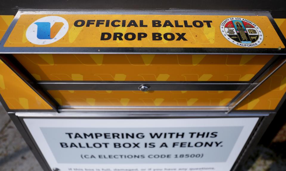 An official mail-in ballot drop box is posted outside of a library ahead of Election Day on October 5, 2020, in Los Angeles, Calif. One of these boxes was set on fire in an incident officials are investigating as arson.