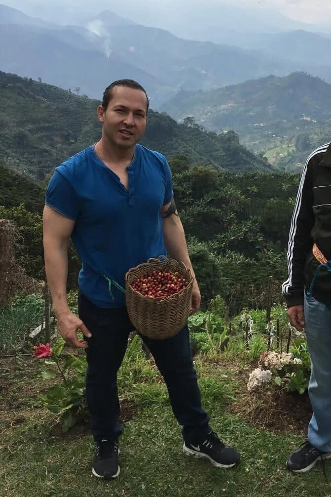 In this photo provided by the Hernandez family, Eyvin Hernandez picks coffee beans while on vacation in Colombia in 2019. Hernandez, from Los Angeles, is one of at least three American citizens who were quietly arrested in 2022 allegedly trying to enter Venezuela illegally and are being held at a maximum security prison facing long sentences, The Associated Press has learned. (Hernandez family via AP)