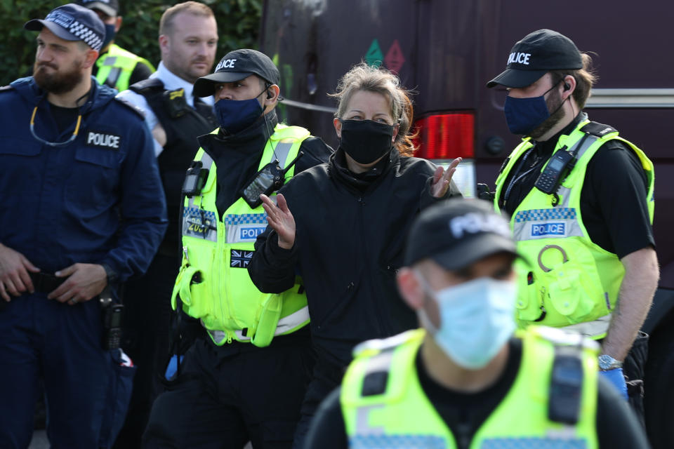 One protester is lead away by police outside the Newsprinters printing works at Broxbourne, Hertfordshire, other protesters use bamboo lock-ons and a van to continue to block the road. (Photo by Yui Mok/PA Images via Getty Images)