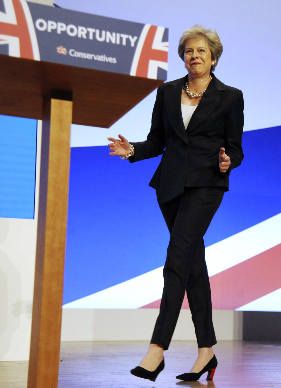 FILE - In this Wednesday, Oct. 3 , 2018 file photo Conservative Party Leader and Prime Minister Theresa May dances as she arrives on stage to address delegates during a speech at the Conservative Party Conference at the ICC, in Birmingham, England. (AP Photo/Rui Vieira)