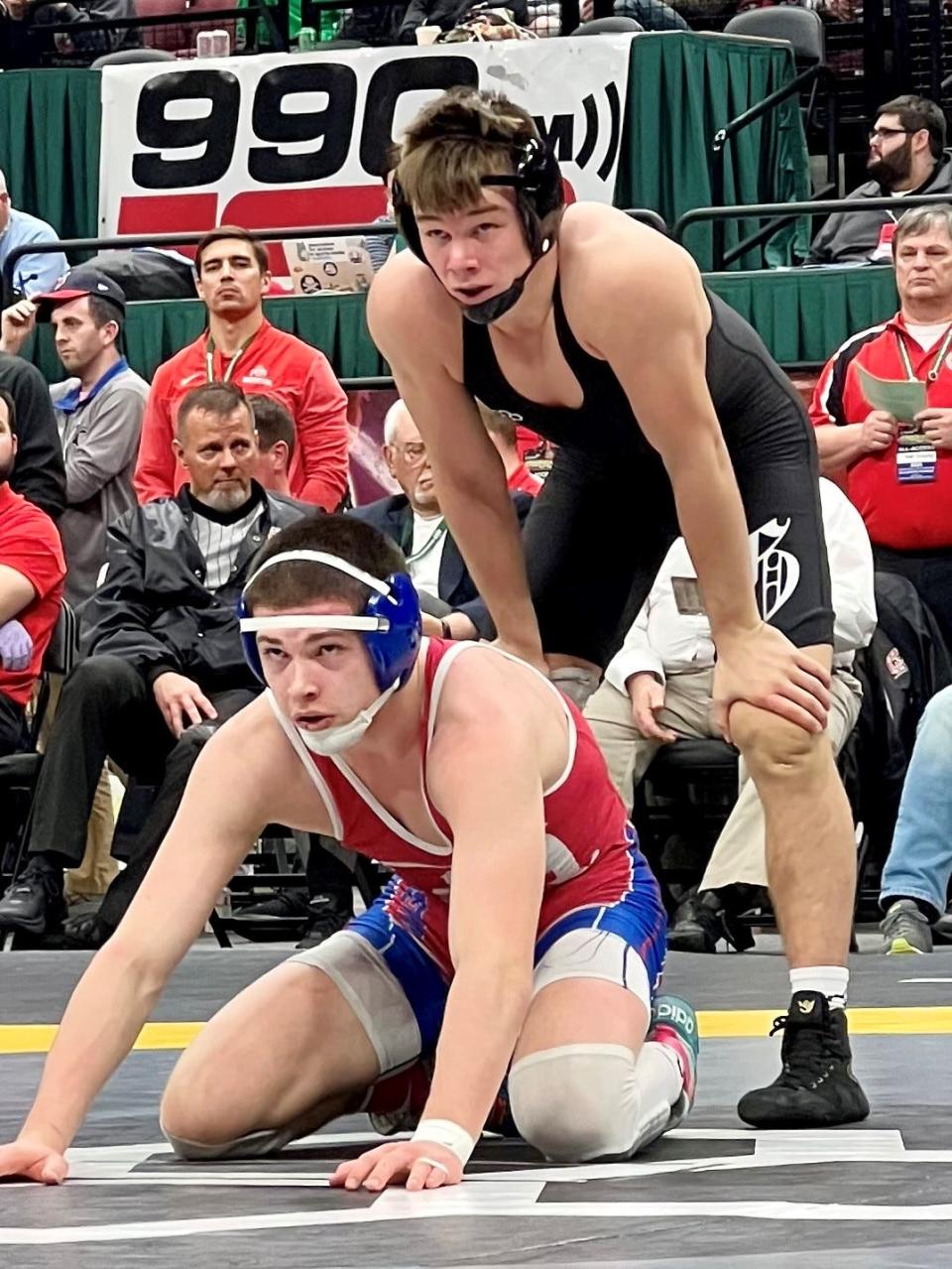 Highland's Cael Gilmore, down, wrestles Graham's Brogan Tucker  in the Division II 144-pound state wrestling tournament championship bout Sunday night at Ohio State's Schottenstein Center.