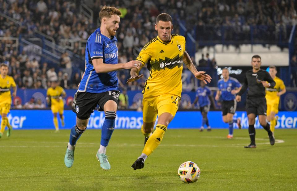 May 15, 2024; Montreal, Quebec, CAN; CF Montreal defender Joel Waterman (16) dribbles against Columbus Crew forward Christian Ramirez (17) during the second half at Stade Saputo. Mandatory Credit: Eric Bolte-USA TODAY Sports