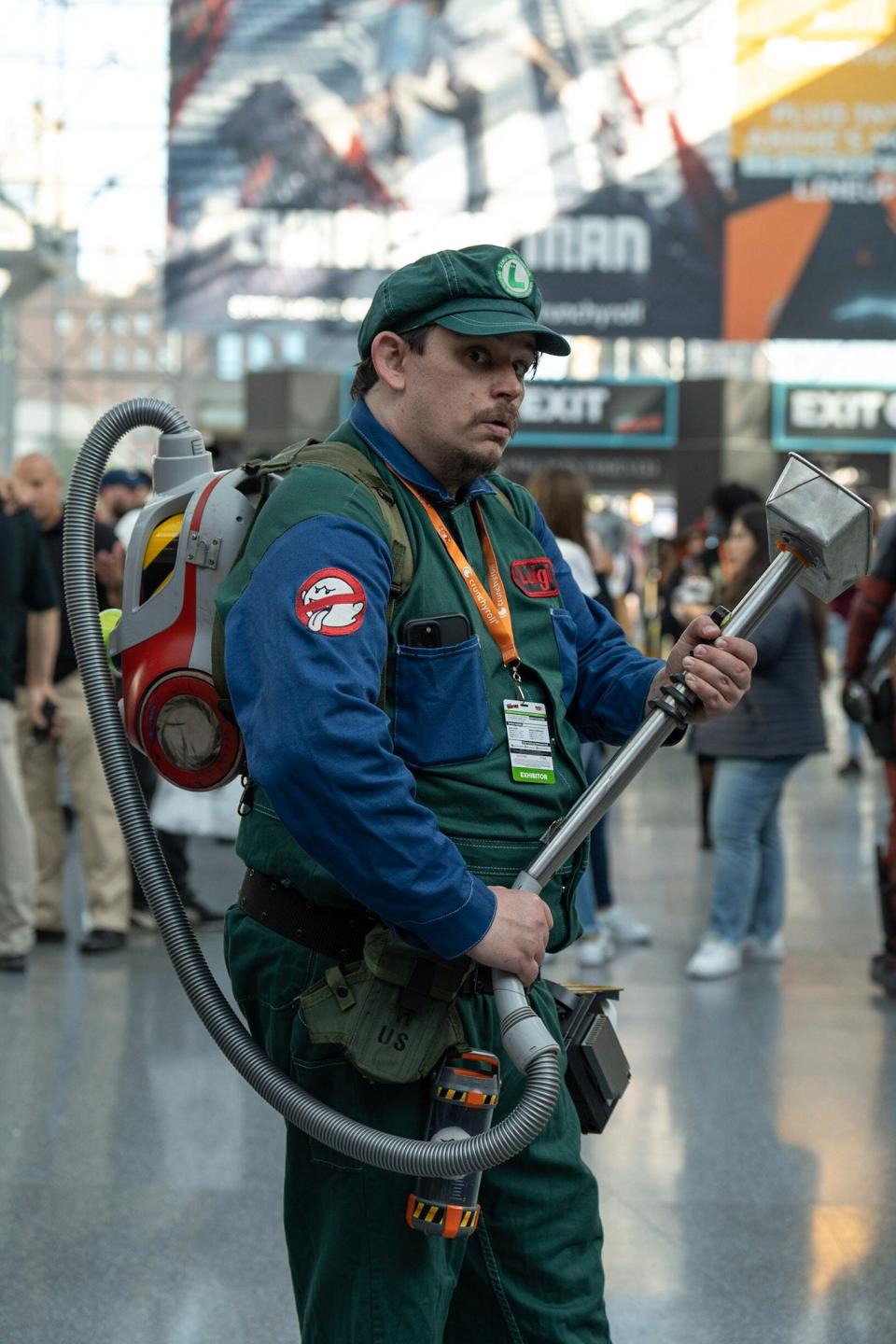 A cosplayer dressed as a mashup of a Ghostbuster and Luigi at New York Comic Con 2022.