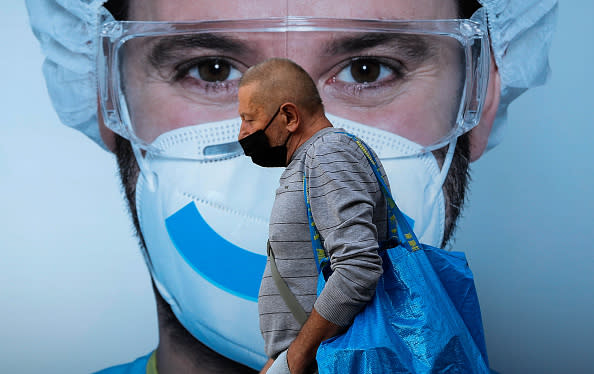 A man with a protective face mask walks in Vellaces neighbourhood.