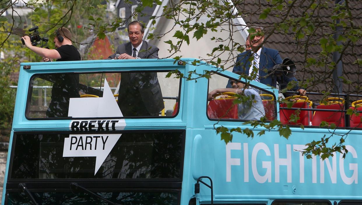 Brexit Party leader Nigel Farage (C) arrives by open top bus to attend a European Parliament election campaign rally in Merthyr Tydfil, south Wales on May 15, 2019. (Photo by GEOFF CADDICK / AFP)        (Photo credit should read GEOFF CADDICK/AFP/Getty Images)