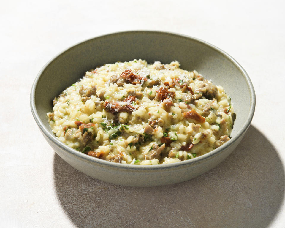 This image released by Milk Street shows a recipe for risotto with sausage and sun-dried tomatoes. (Milk Street via AP)