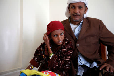 Saida Ahmad Baghili, 18, who has been affected by severe malnutrition, sits with her father at a hotel in Sanaa, Yemen December 4, 2016. REUTERS/Khaled Abdullah