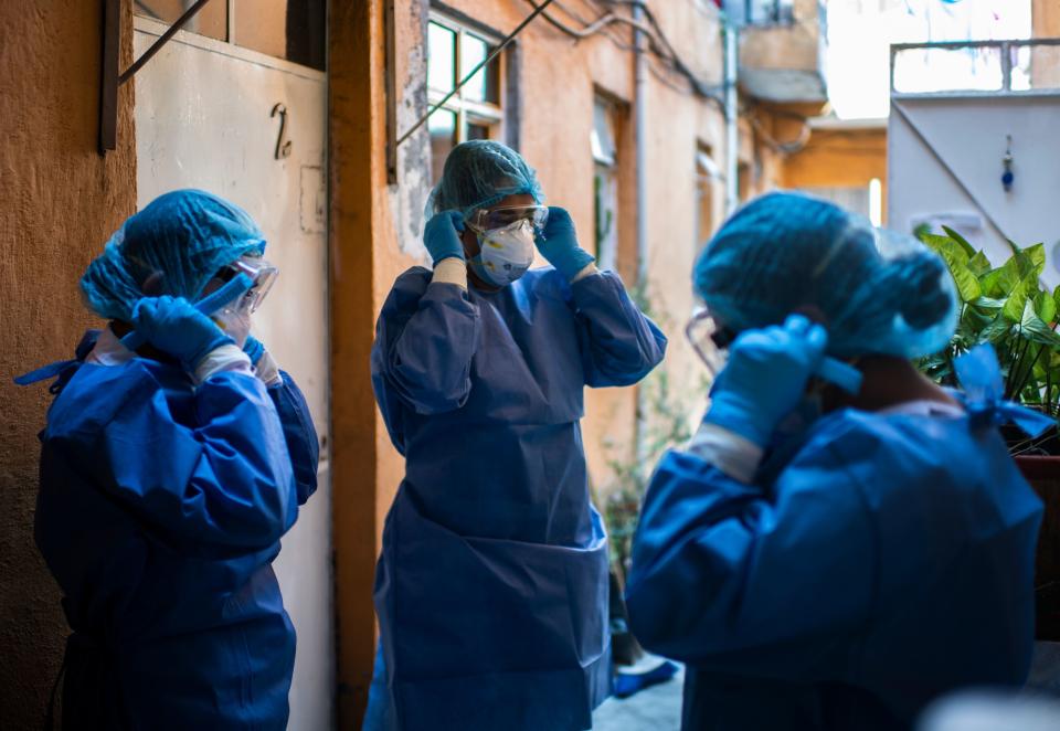 A health brigade gets ready while on door-to-door visits to carry out COVID-19 tests in Mexico City, on June 16, 2020, amid the new coronavirus pandemic. (Photo by PEDRO PARDO / AFP) (Photo by PEDRO PARDO/AFP via Getty Images)