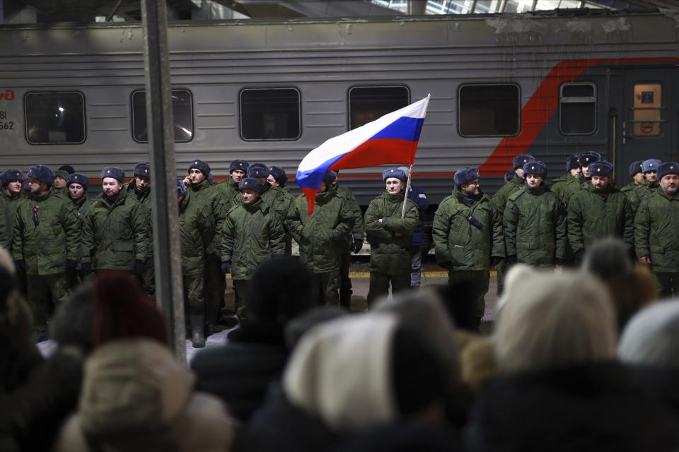 Soldiers who were recently mobilized by Russia for the military operation in Ukraine stand at a ceremony before boarding a train at a railway station in Tyumen, Russia, Friday, Dec. 2, 2022. Russian President Vladimir Putin's order to mobilize reservists for the conflict prompted large numbers of Russians to leave the country. (AP Photo)