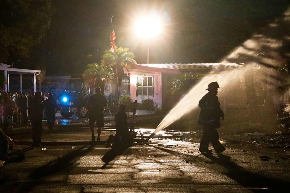 <p>Octavio Jones/AFP/Getty</p> Firefighters work to put out a fire after a small plane crashed into the Bayside Waters mobile home park in Clearwater, Fla., on Feb. 1, 2024. 