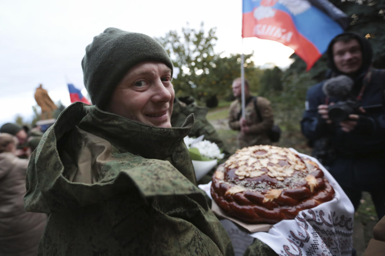 A prisoner, one of 14 released by Ukraine as a prisoner swap, is greeted by people in Novoazovsk, separatist Donetsk People's Republic, eastern Ukraine, Friday, Oct. 21, 2022. (AP Photo/Alexei Alexandrov)