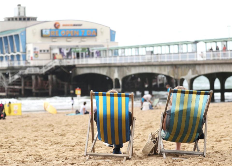 People relax on deckchairs (PA) (PA Archive)