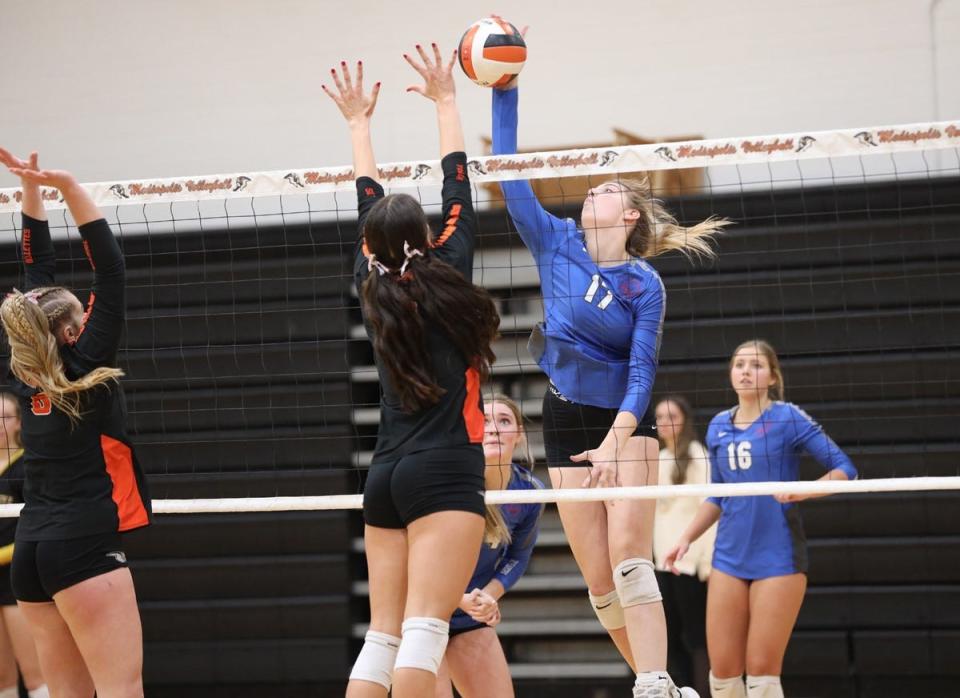 Holy Trinity freshman Presley Myers goes for a kill over Mediapolis’ Hanna Wagenbach in the Mediapolis Quad held Thursday night at Mediapolis.
