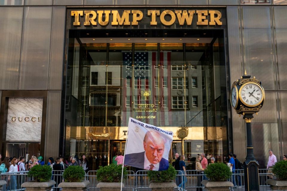 A banner bearing Donald Trump’s notorious mugshot is flown outside Trump Tower in Manhattan, New York City (Reuters)