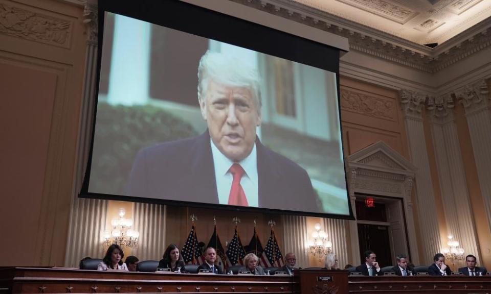 Donald Trump appears on a video screen as Cassidy Hutchinson testifies before the 6 January panel.