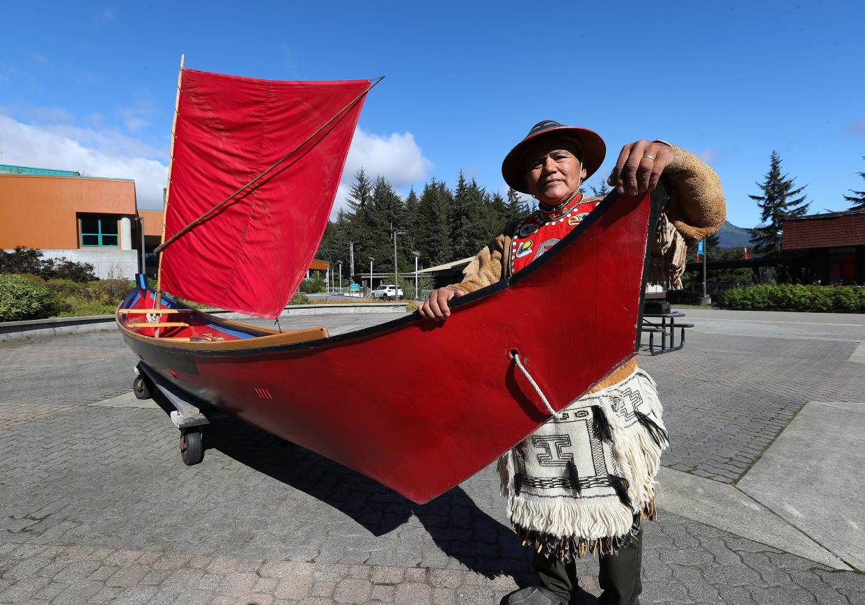 Wayne Price, of the Tlingit Nation, stands next to a healing canoe he carved at the University of Alaska Southeast in Juneau, Alaska, on Aug. 27, 2023. Price talked about how he overcame his own addiction through carving.