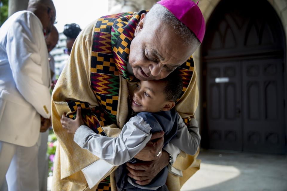 Archbishop of Washington Wilton Gregory hugs Noah Tanner, 4, at St. Augustine Catholic Church in June 2019.