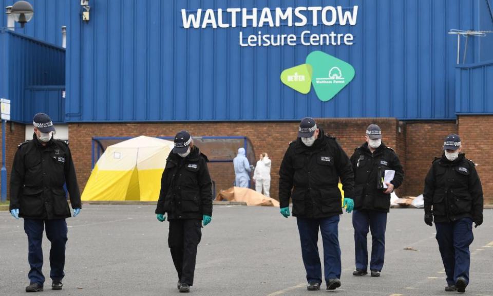 Police and forensic officers search the scene in Walthamstow where a 16-year-old boy was shot on Monday evening