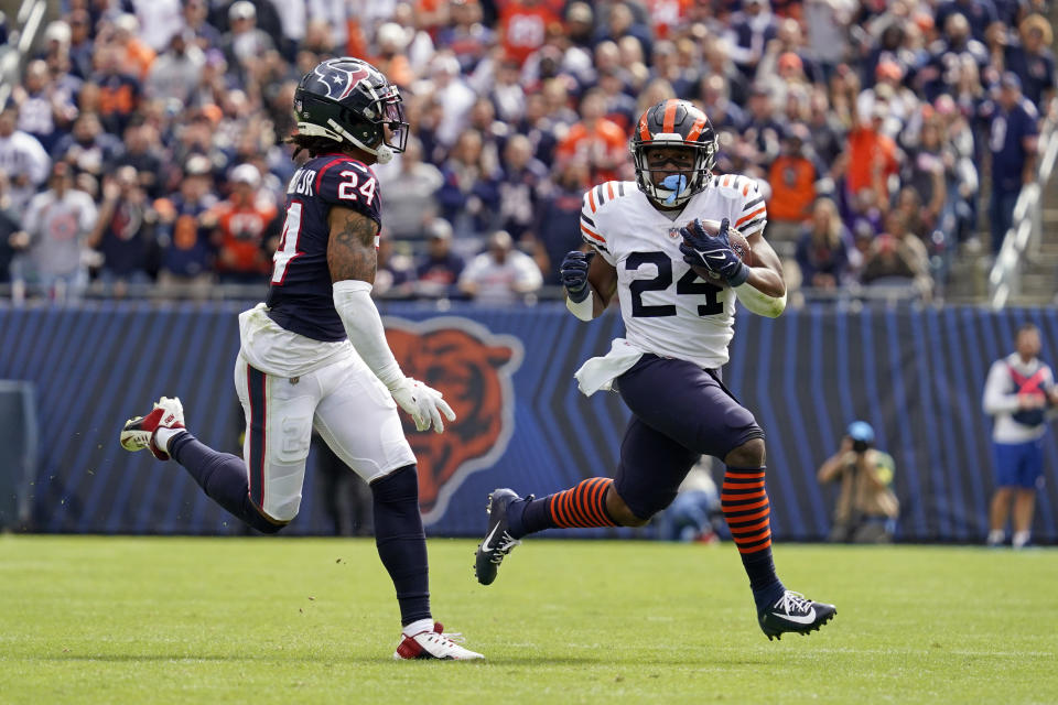 Chicago Bears running back Khalil Herbert, right, runs for a gain of 52 yards as Houston Texans cornerback Derek Stingley Jr. defends during the second half of an NFL football game Sunday, Sept. 25, 2022, in Chicago. (AP Photo/Nam Y. Huh)