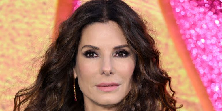 sandra bullock looking at the camera, hair down and curly at the lost city premiere