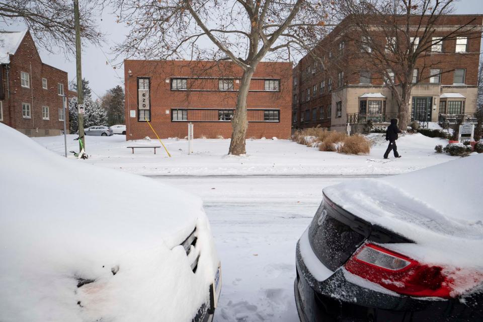 Brad Stimson, from Columbus, walks down the sidewalk on East Town Street on Friday morning after unsuccessfully trying to enter his car to go to work. “My door is frozen shut so it looks like I’m inside for the day,” he said.