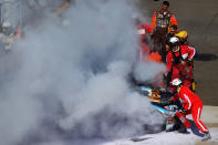 BROOKLYN, MI - JUNE 17: Safety crew members put out the fire on the #11 FedEx Office Toyota of Denny Hamlin after it burst into flames as a result of an incident during the NASCAR Sprint Cup Series Quicken Loans 400 at Michigan International Speedway on June 17, 2012 in Brooklyn, Michigan. (Photo by Drew Hallowell/Getty Images for NASCAR)