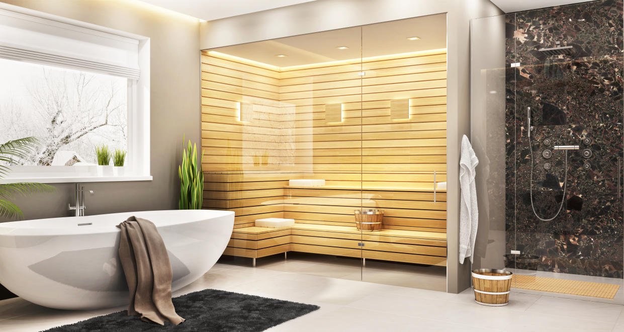 Beautiful bathroom with white bath and sauna and shower in a modern home