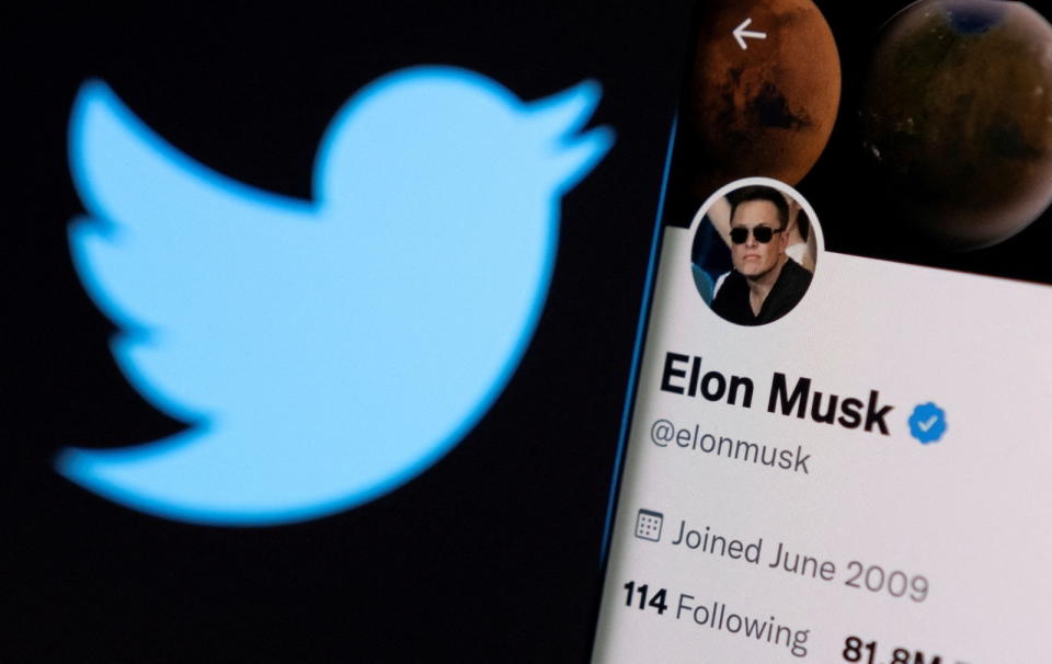 Elon Musk's twitter account is seen on a smartphone in front of the Twitter logo in this photo illustration taken, April 15, 2022. REUTERS/Dado Ruvic/Illustration