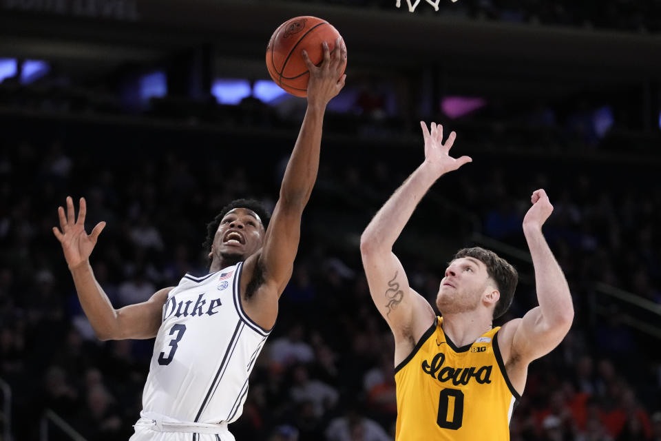 Duke's Jeremy Roach (3) shoots against Iowa's Filip Rebraca (0) during the first half of the team's NCAA college basketball game in the Jimmy V Classic, Tuesday, Dec. 6, 2022, in New York. (AP Photo/John Minchillo)