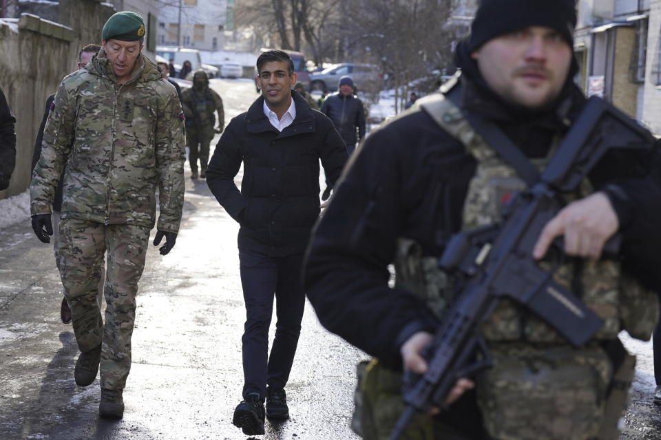 Prime Minister Rishi Sunak and Vice Chief of the Defence Staff, Major General Gwyn Jenkins, left, are shown damaged buildings in Kyiv, Ukraine, ahead of meeting with President Volodymyr Zelenskyy to announce a major new package of military aid to Ukraine, Friday, Jan. 12, 2024. (Stefan Rousseau/Pool via AP)