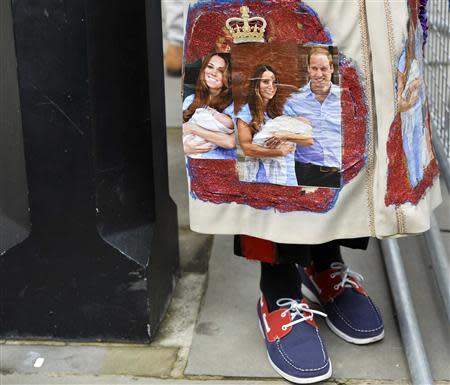 A royal fan stands outside St James's Palace before the christening of Prince George in London October 23, 2013. REUTERS/Toby Melville