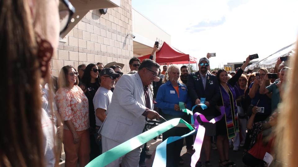 Lorenzo Alba Jr., executive director for Casa de Peregrinos, slices inaugural ribbons celebrating the completion of a newly renovated city-owned building that will serve as the Las Cruces nonprofit’s warehouse and distribution center. The new facility replaces an aging, too-small building located ust to the south.