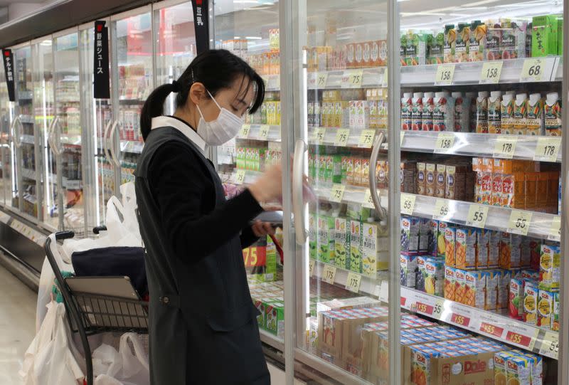 An employee picks out products to fulfil online orders at a Seiyu store in Tokyo