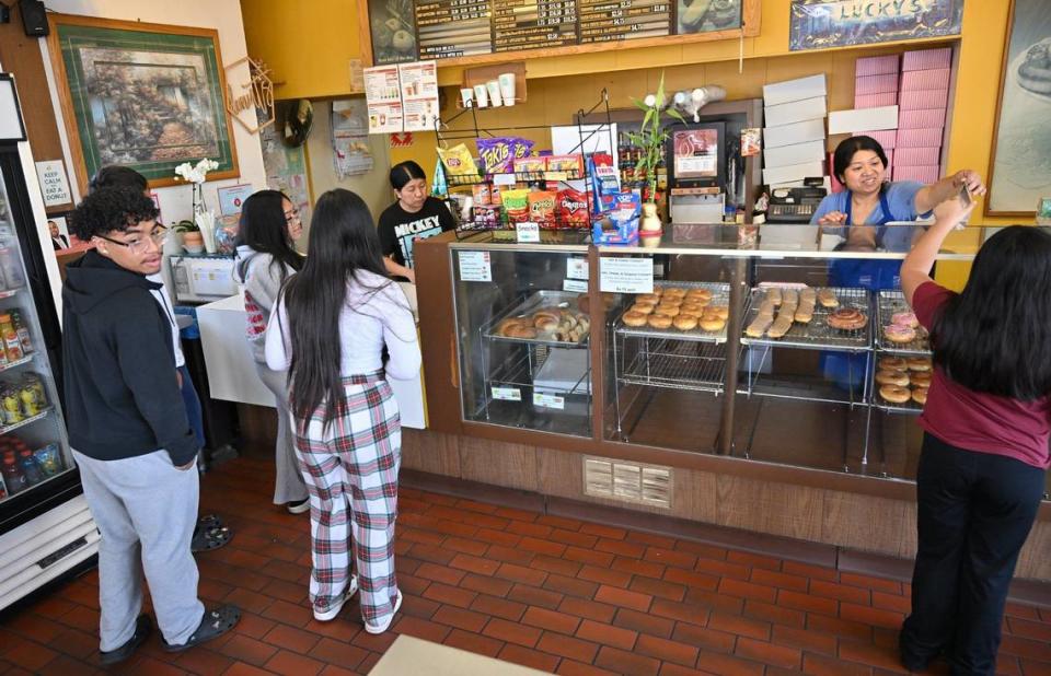 Customers purchase donuts at Lucky’s Donut House Monday, May 20, 2024 in Fresno. Judy Taing, part-owner of the family business said the property owner gave them notice to leave, closing down the family’s Lucky’s Donut House location after over 30 years at Shields and West avenues.