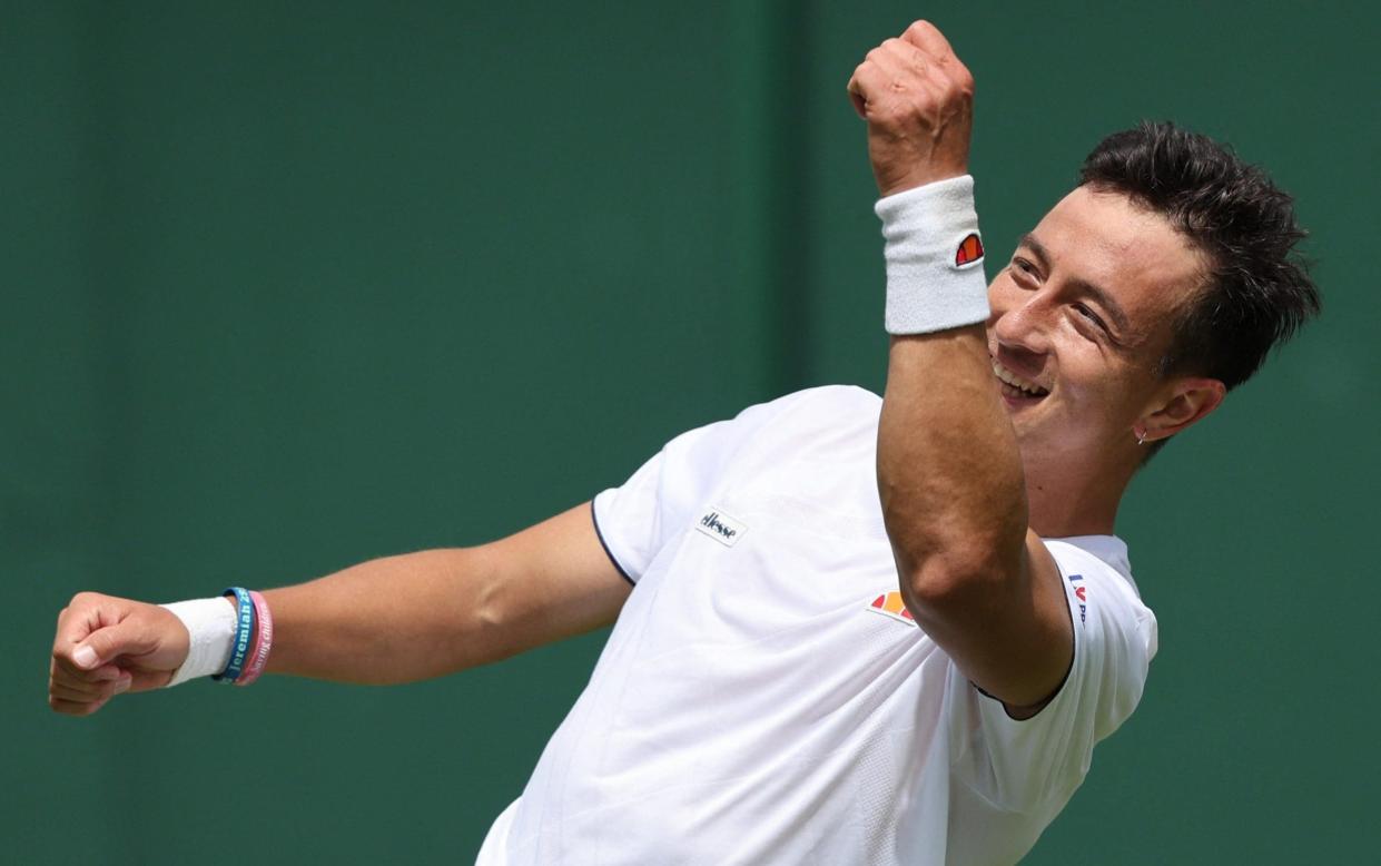 Britain's Ryan Peniston celebrates beating Switzerland's Henri Laaksonen during their men's singles tennis match on the second day of the 2022 Wimbledon Championships at The All England Tennis Club in Wimbledon, southwest London, on June 28, 2022 - British wildcard Ryan Peniston takes Wimbledon by storm - after surviving horrific cancer battle - GETTY IMAGES