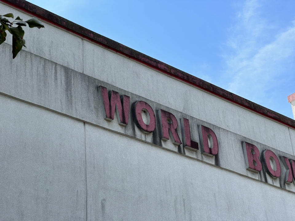 <p>A photo from the iPhone 14 Pro's telephoto camera at 3x zoom closing up on the word "World" on an aging sign for a gym against a blue sky.</p>
