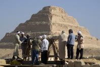 Egyptian antiquities workers dig at the site of the Step Pyramid of Djoser in Saqqara, 24 kilometers (15 miles) southwest of Cairo, Egypt, Thursday, Jan. 26, 2023. Egyptian archaeologist Zahi Hawass, the director of the Egyptian excavation team, announced that the expedition found a group of Old Kingdom tombs dating to the fifth and sixth dynasties of the Old Kingdom, indicating that the site comprised a large cemetery. (AP Photo/Amr Nabil)