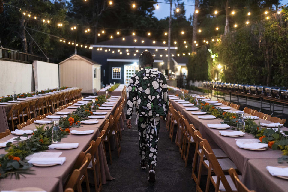 Shalomyah Bowers, a board member of the Black Lives Matter Global Network Foundation, walks between dinner tables set for a welcome dinner for the annual Families United 4 Justice Network Conference, hosted by the foundation at its mansion in the Studio City neighborhood of Los Angeles, on Thursday, Sept. 28, 2023. A national Black Lives Matter nonprofit that was widely criticized for purchasing a sprawling California mansion with donated funds recently opened the property to dozens of families who lost loved ones in incidents of police violence. (AP Photo/Jae C. Hong)