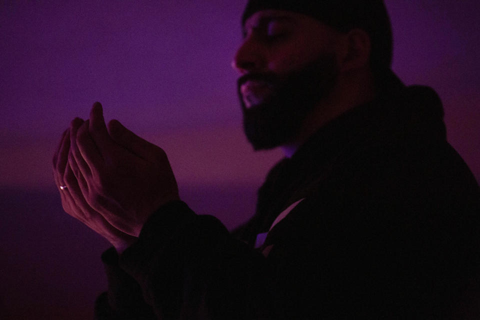 Mohammed Widdi, 31, coordinator of Muslims Giving Back, performs nighttime prayers for the month of Ramadan at the Muslim Community Center in Brooklyn before heading out to the city to hand out food to the hungry, in New York, on Monday, April 27, 2020. (AP Photo/Wong Maye-E)