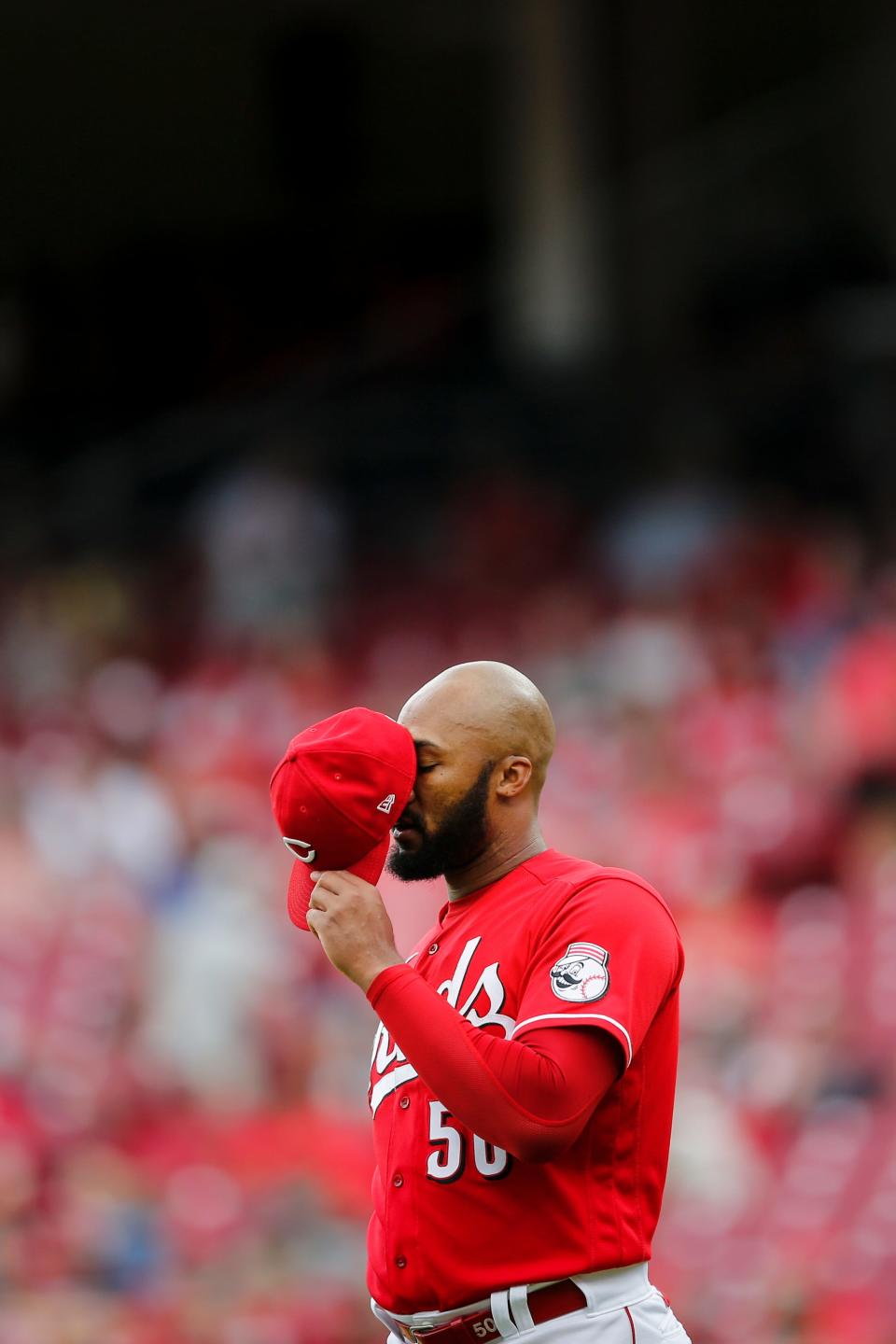 Cincinnati Reds relief pitcher Amir Garrett (50) takes a moment before delivering the ball in the seventh inning of the MLB Interleague game between the Cincinnati Reds and the Minnesota Twins at Great American Ball Park in downtown Cincinnati on Wednesday, August 4, 2021.