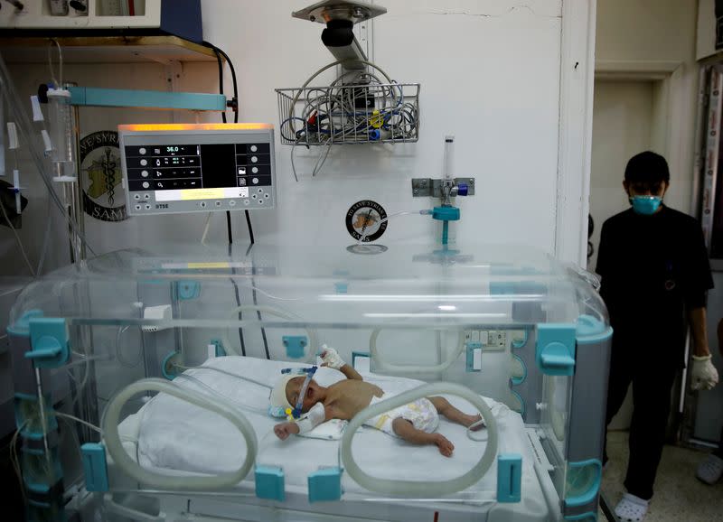 A premature baby is seen in an incubator at a maternity hospital in Idlib