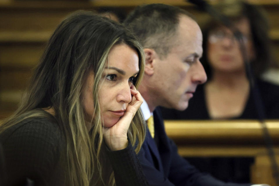 Defendant Karen Read sits with her defense team during her murder trial, Tuesday, April 30, 2024, in Dedham, Mass. Read, 44, of Mansfield, faces several charges including second degree murder in the death of her Boston Police officer boyfriend John O’Keefe, 46, in 2022. (Nancy Lane/The Boston Herald via AP, Pool)