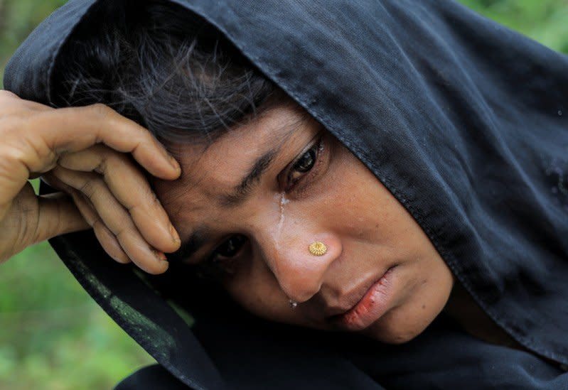 A Rohingya refugee woman who crossed the border from Myanmar cries while waiting to get a shelter in Kotupalang refugee camp near Cox's Bazar, Bangladesh October 21, 2017. REUTERS/ Zohra Bensemra