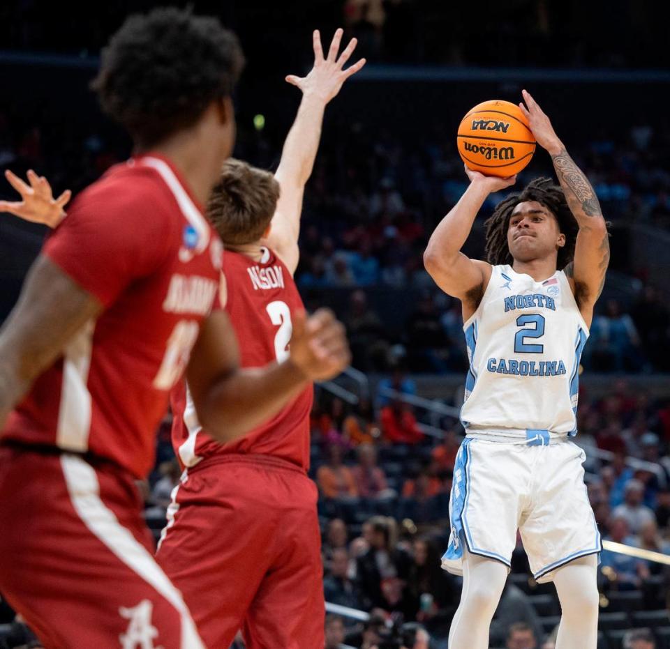 North Carolina’s Elliot Cadeau (2) launches a three point shot over Alabama’s Grant Nelson (2) in the first half during the NCAA Sweet Sixteen on Thursday, March 28, 2024 at Crypto.com Arena in Los Angeles, CA.