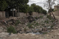 Trash fills a water canal in an impoverished area where people have been greatly affected by the coronavirus outbreak, in Cairo, Egypt, Thursday, April 9, 2020. (AP Photo/Nariman El-Mofty)