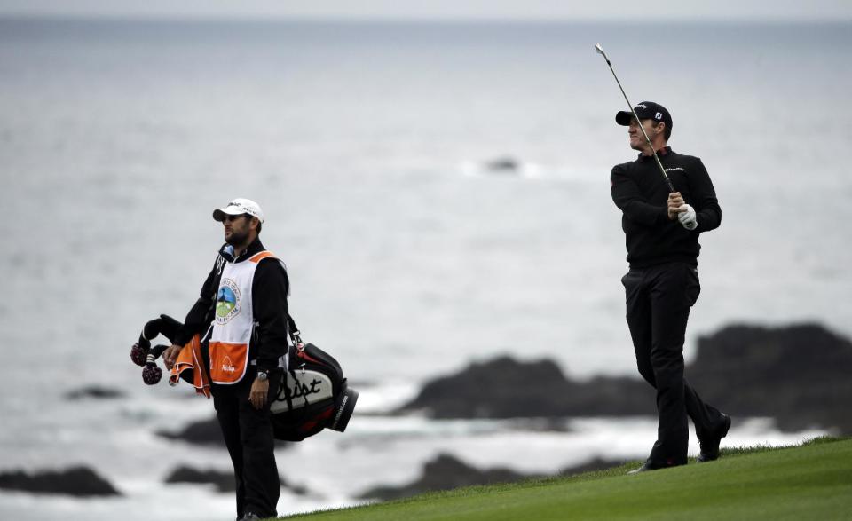 Jimmy Walker, right, follows through on his shot on the ninth fairway Sunday, Feb. 9, 2014, during the final round of the AT&T Pebble Beach Pro-Am golf tournament in Pebble Beach, Calif. (AP Photo/Ben Margot)