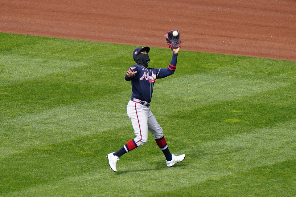 Atlanta Braves center fielder Cristian Pache catches a fly out by Philadelphia Phillies' Rhys Hoskins during the first inning of an opening day baseball game, Thursday, April 1, 2021, in Philadelphia. (AP Photo/Matt Slocum)