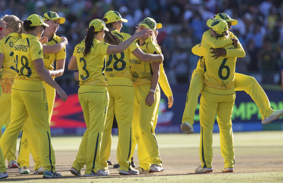 Australia celebrate after winning against South Africa in the Women's T20 World Cup semi final cricket match between South Africa and Australia, in Cape Town, South Africa, Sunday Feb. 26, 2023. (AP Photo/Halden Krog)